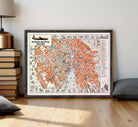 The image is a framed vintage map of Prague, Czech Republic, depicting the city's streets and landmarks in an orange and black color scheme.