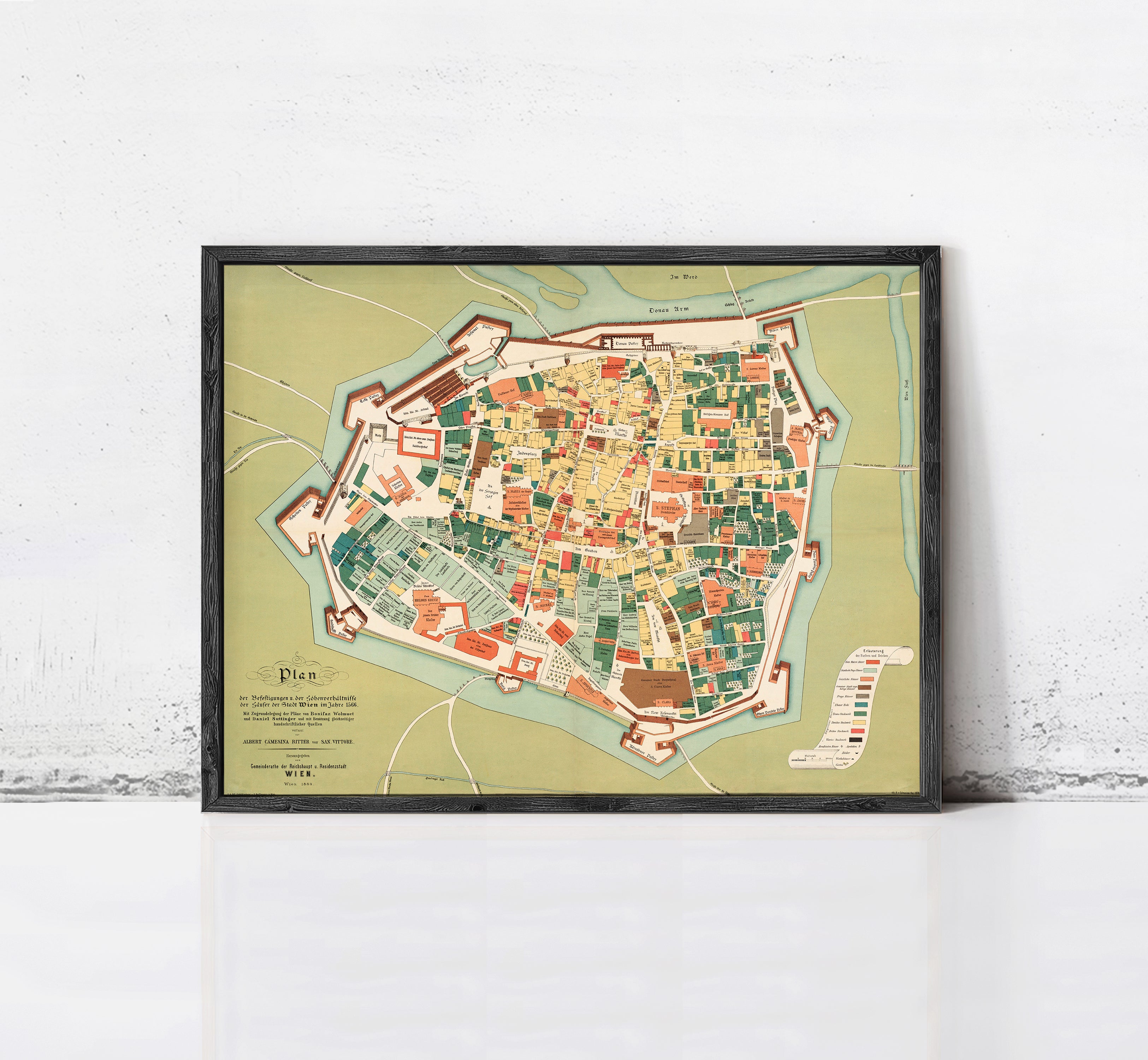 The image is a framed map of a city, depicting a detailed layout of the streets, buildings, and other urban features.