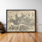 A framed illustration of a map of London, depicting the city's streets and landmarks.