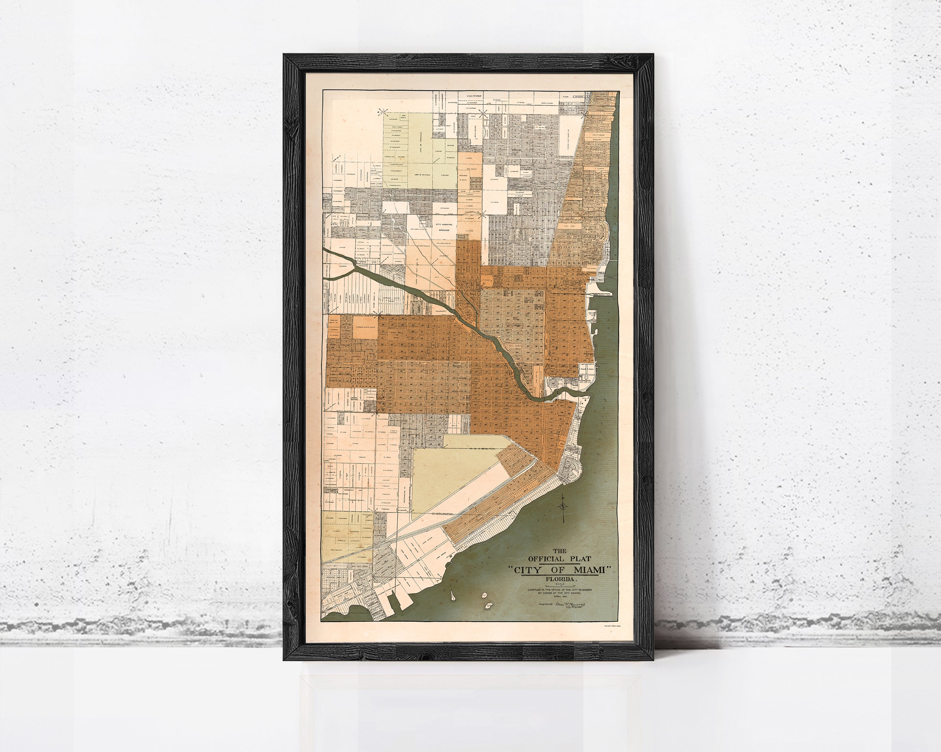 The image is a framed map of Miami, Florida, showing the city's layout and surrounding areas.