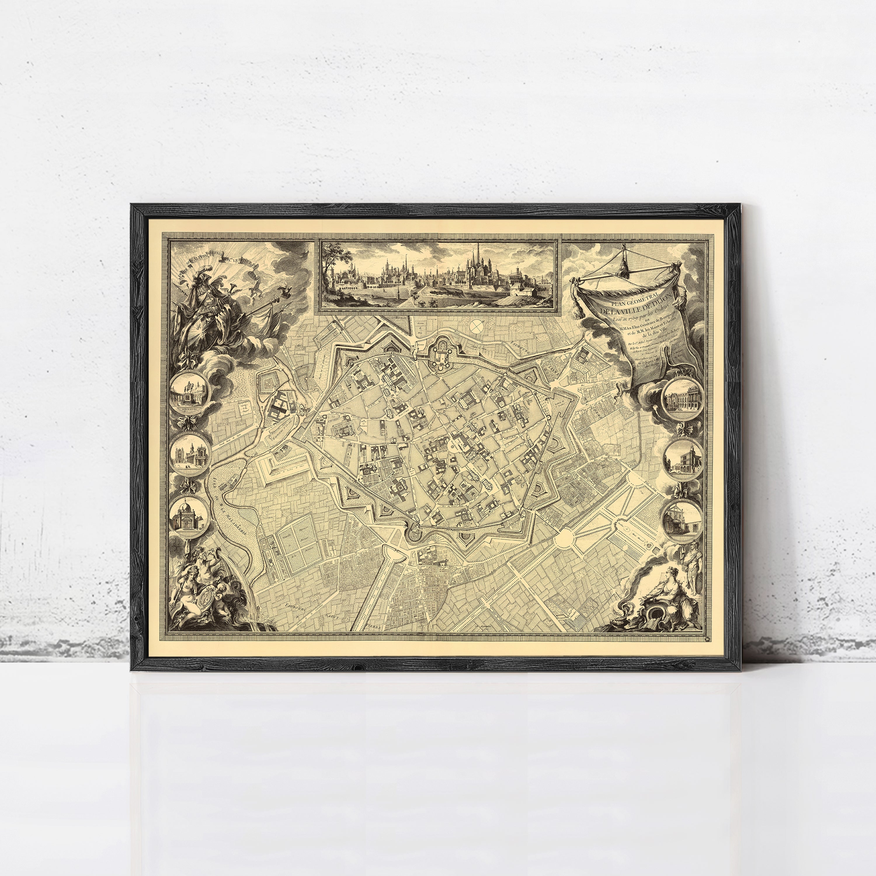 The image is a framed antique map of a city, depicting a detailed layout of the streets and surrounding areas.