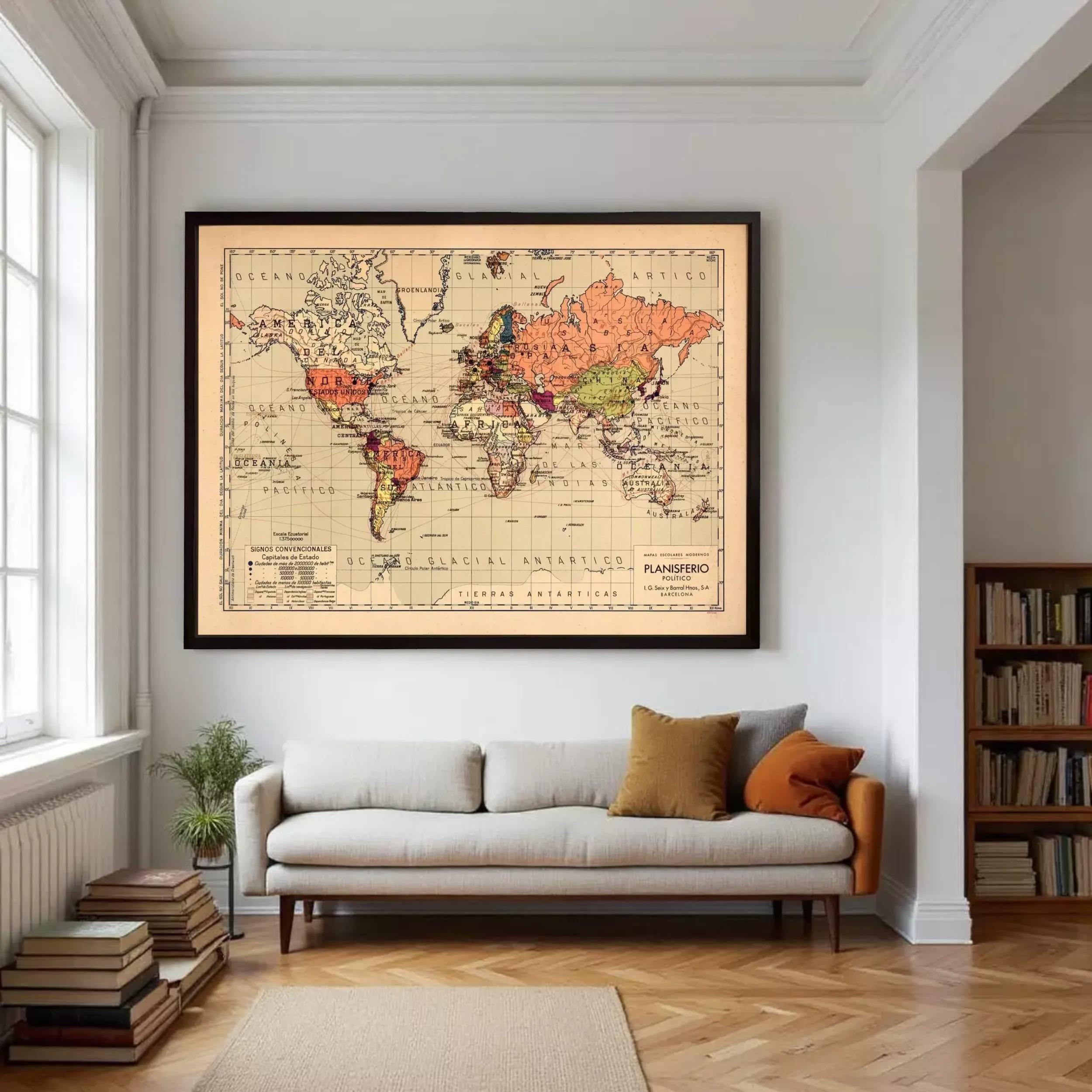 a large world map hanging on a wall in a living room, with a couch and bookshelves below it.