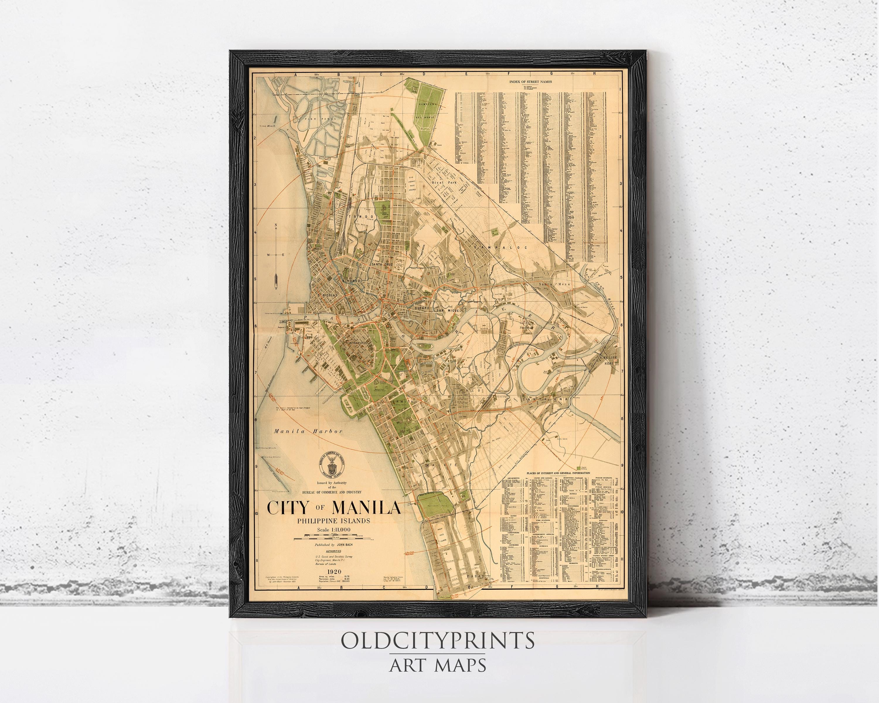 The image is a framed vintage map of Manila, Philippines, depicting the city's layout and surrounding areas.