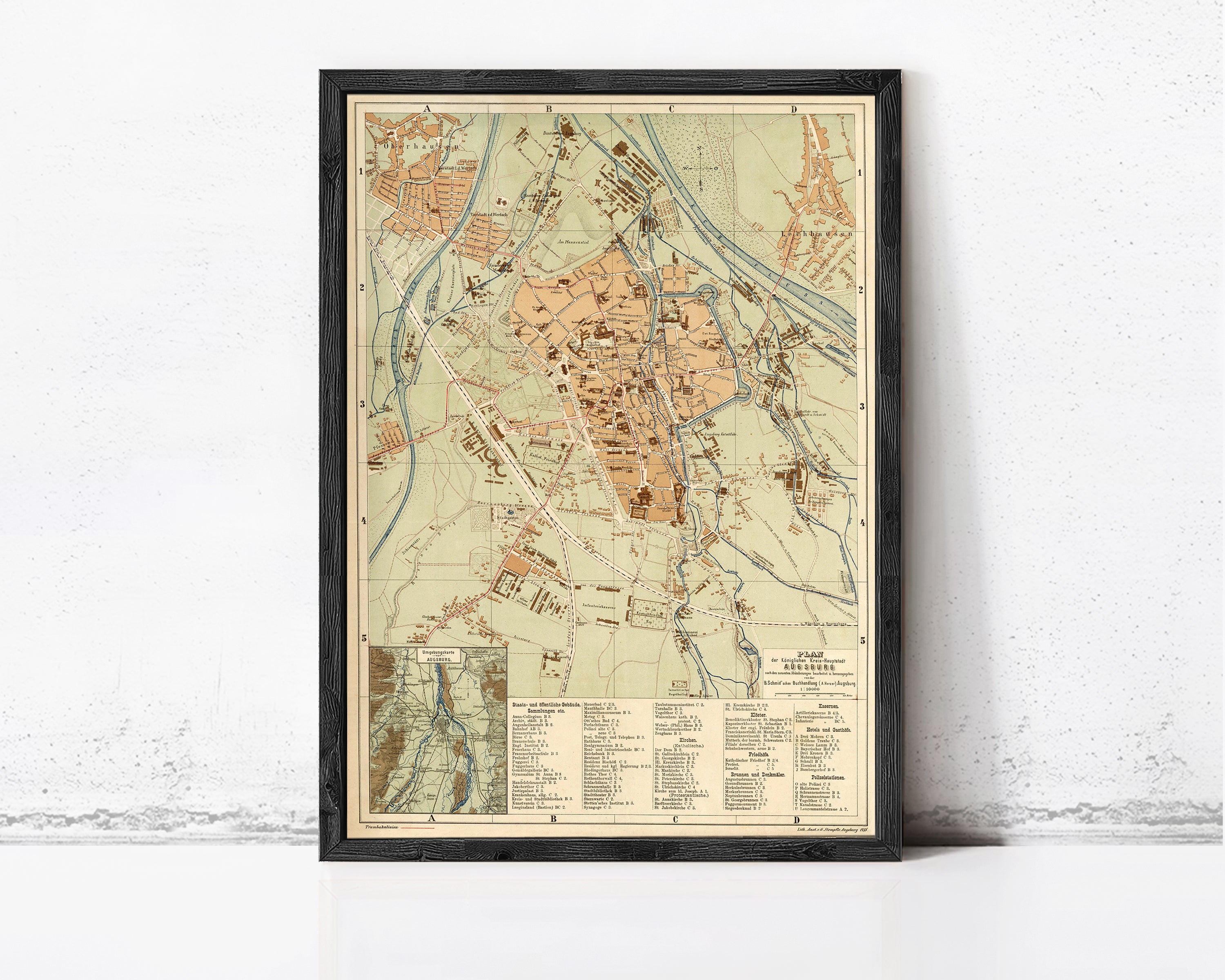 The image is a framed vintage map of a city, likely from the 19th century, with detailed geographical information and labels.
