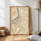 The image is a framed map of a city, likely from an Asian country, displayed on a wall.