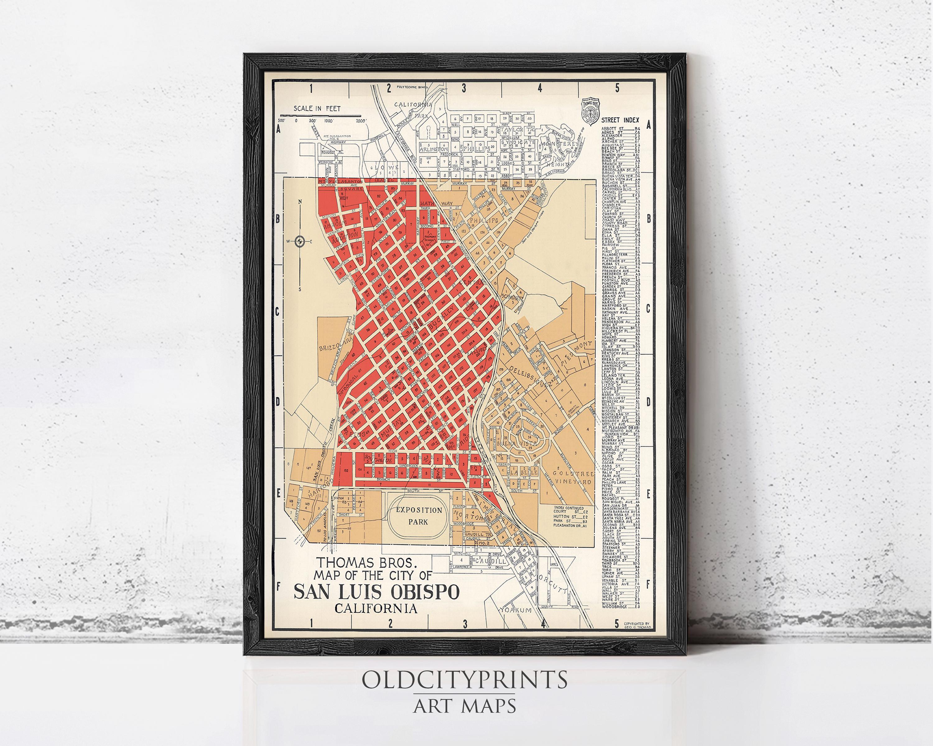 The image is a framed vintage map of San Luis Obispo, California, depicting a detailed street layout and surrounding areas.