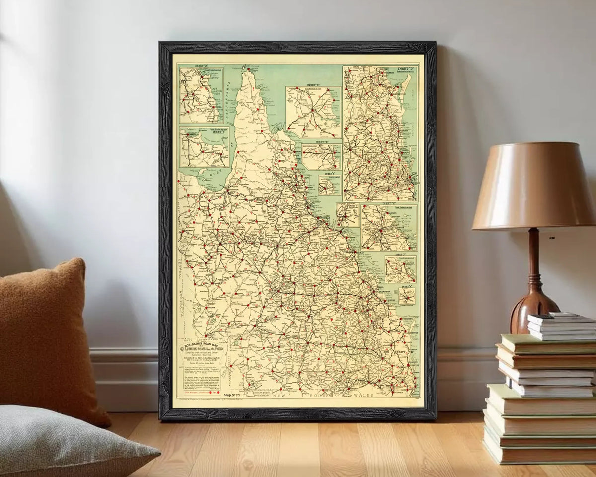 a framed map of the state of Utah, with a lamp and a stack of books in the background.