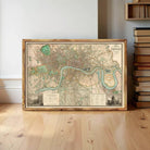 A framed map of London, featuring a detailed representation of the city's streets, landmarks, and waterways.