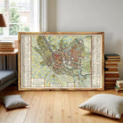 The image is a framed map of a city, likely from the past, with detailed labels and a color scheme that suggests it is a historical or vintage map.