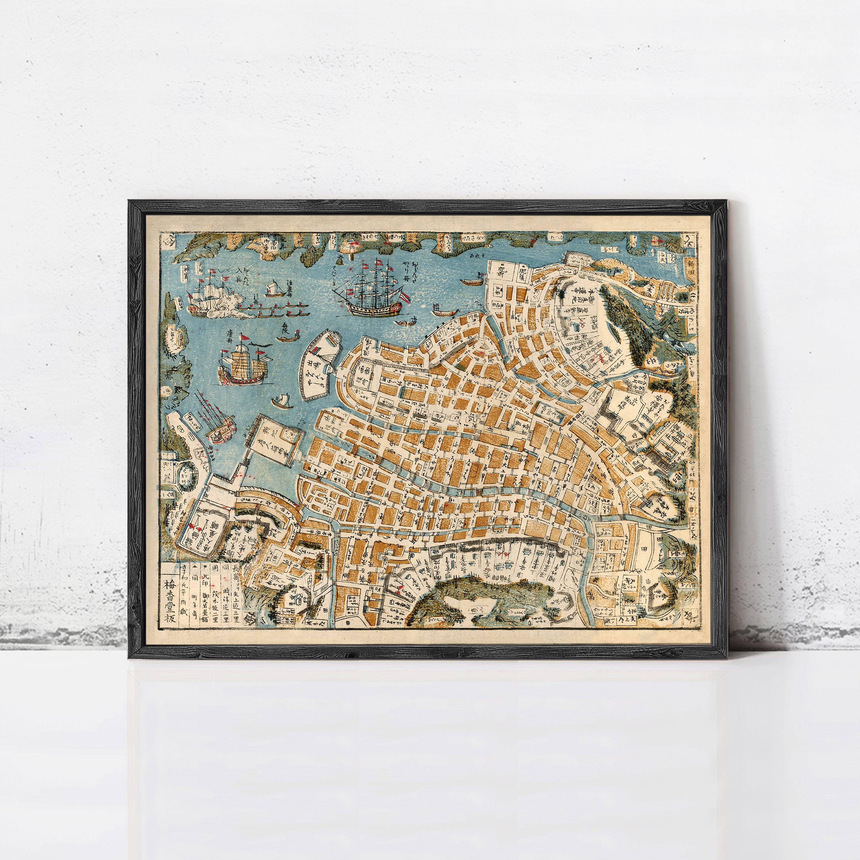 The image is a framed vintage map of a city, depicting various landmarks and streets.