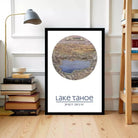 A framed poster of Lake Tahoe is displayed on a wall, with a lamp and bookshelf visible in the background.
