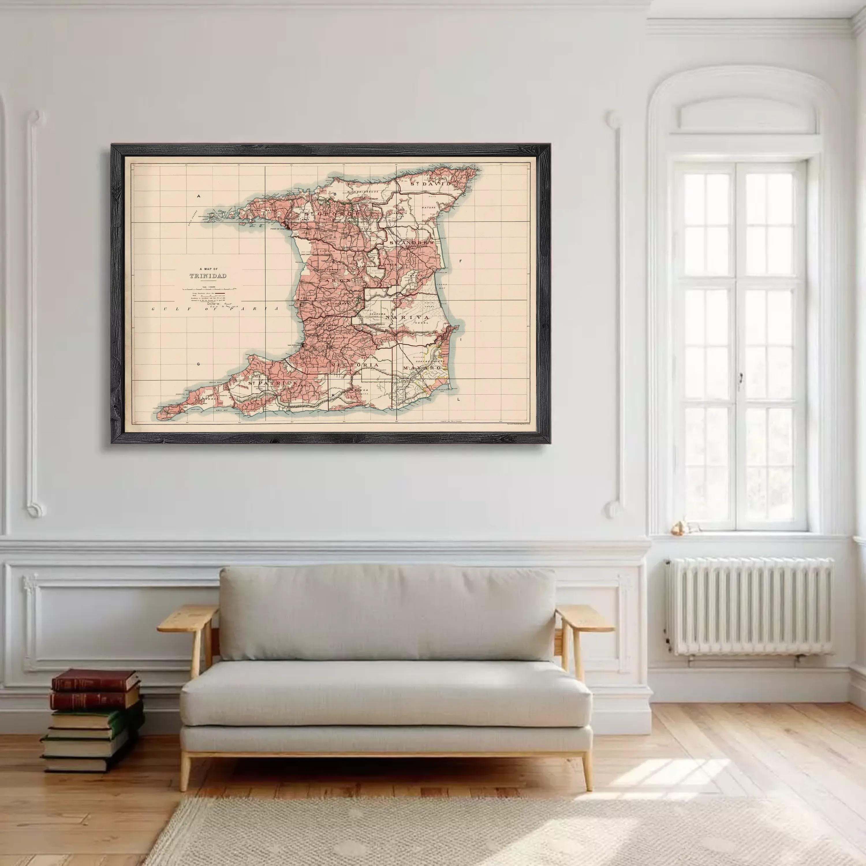 a large framed map of Trinidad and Tobago hanging on a white wall in a living room.