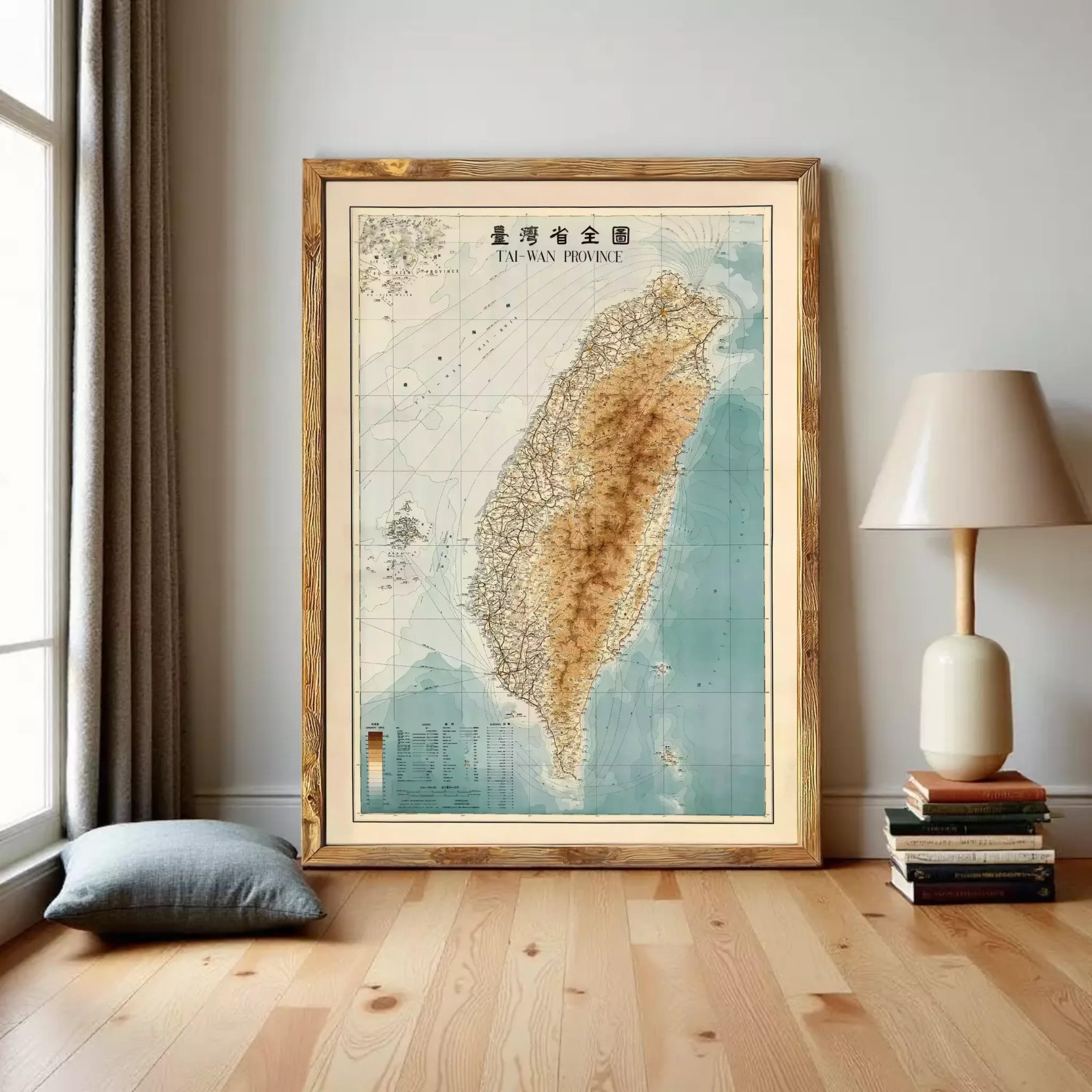 a large framed map of Taiwan, with a lamp and some books placed next to it on a wooden floor.