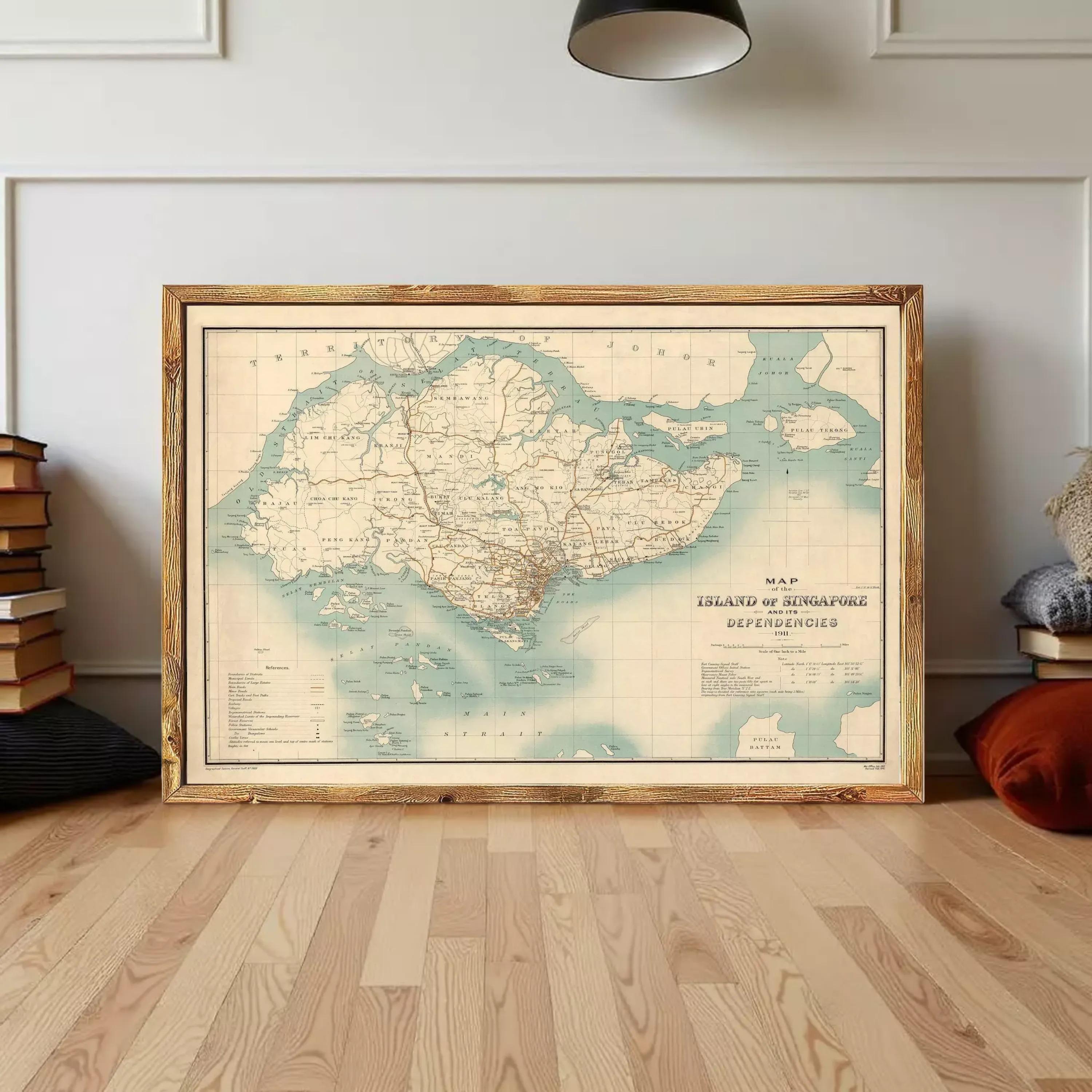 A large framed map of Singapore, depicting the island and its surrounding areas, is displayed on a wooden floor against a white wall.