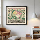 The image is a framed vintage map of a city, depicting a detailed layout of the city's streets, buildings, and other landmarks.
