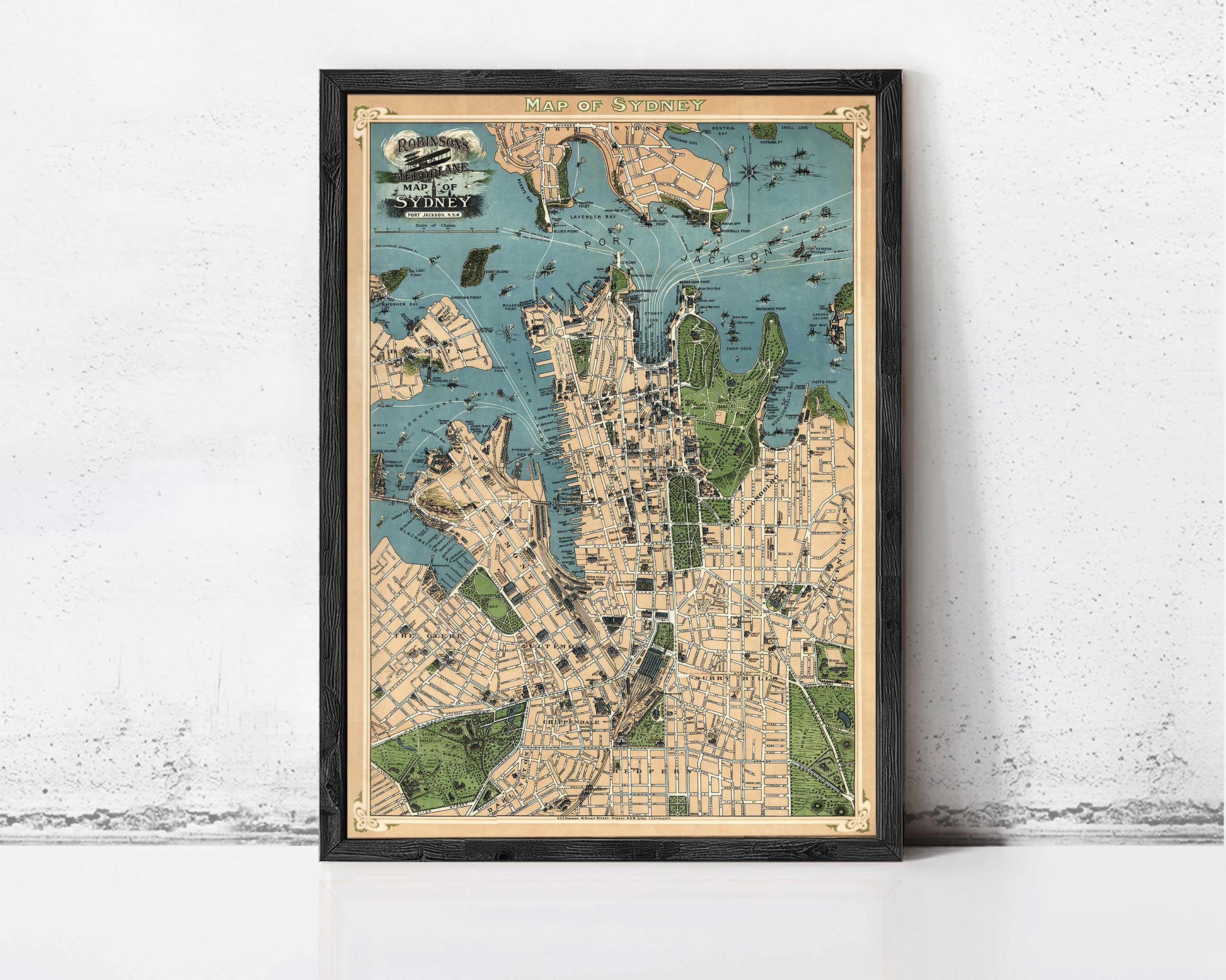The image is a framed vintage map of Sydney, Australia, depicting the city's streets and surrounding areas.