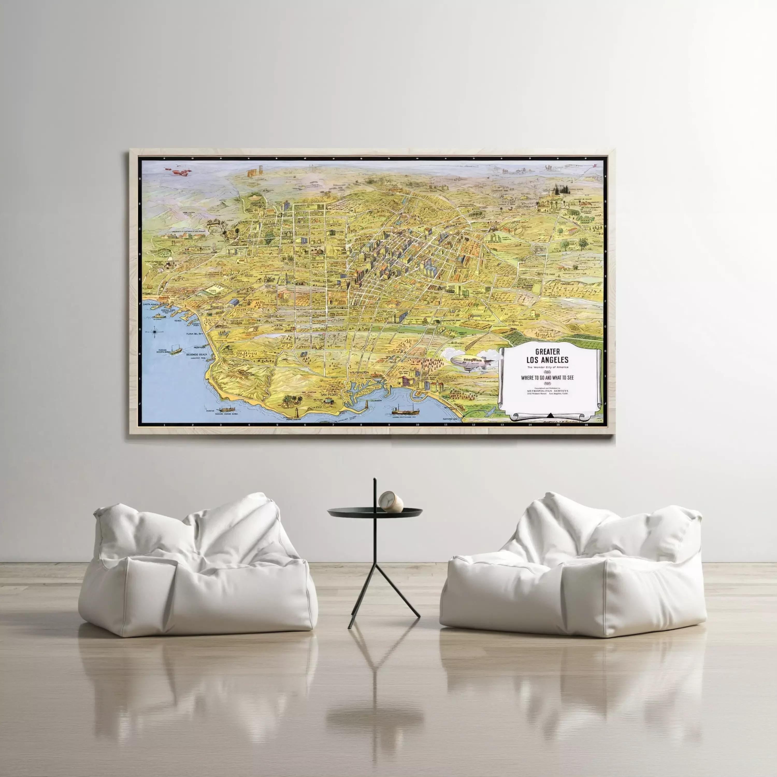 a large wall-mounted map of Los Angeles, with two white bean bag chairs positioned in front of it.