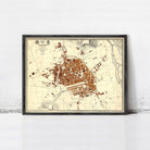 The image is a framed map of a city, likely a historical or vintage map, displayed on a wall.