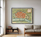 The image is a framed vintage map of a city, depicting a detailed layout of the streets, landmarks, and surrounding areas.