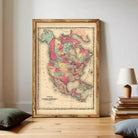 The image is a framed vintage map of North America, depicting the United States and parts of Canada.