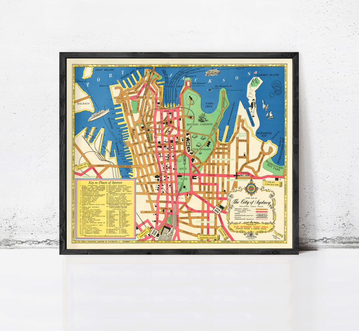 The image is a framed vintage map of a city, likely Sydney, Australia, with various landmarks and streets labeled.