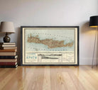 a framed map of Greece, specifically the island of KPHTH, displayed on a wooden floor in a room.