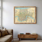 a large framed map of a city hanging on a wall in a living room.