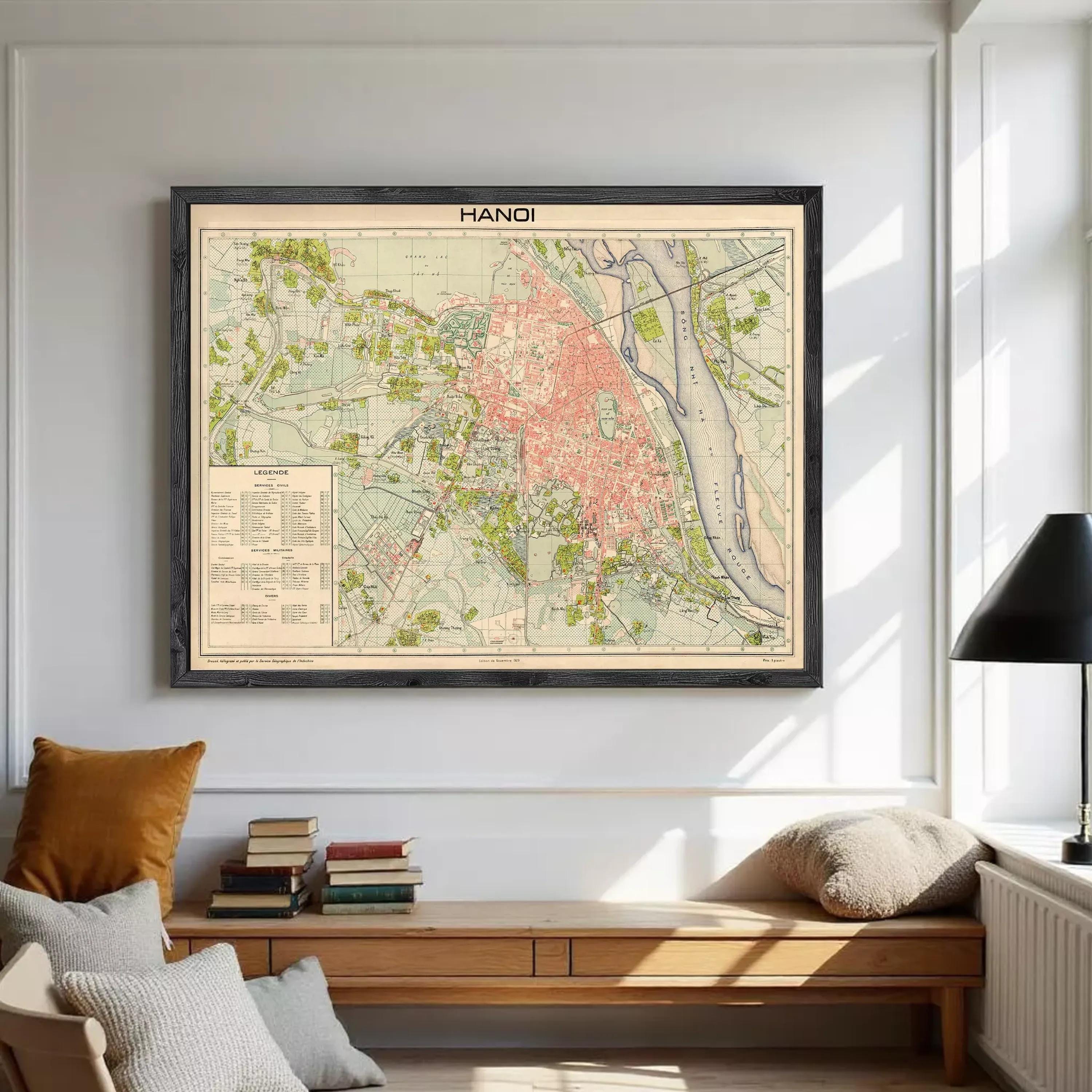 The image is a framed vintage map of Hanoi, Vietnam, depicting the city's streets, landmarks, and surrounding areas.