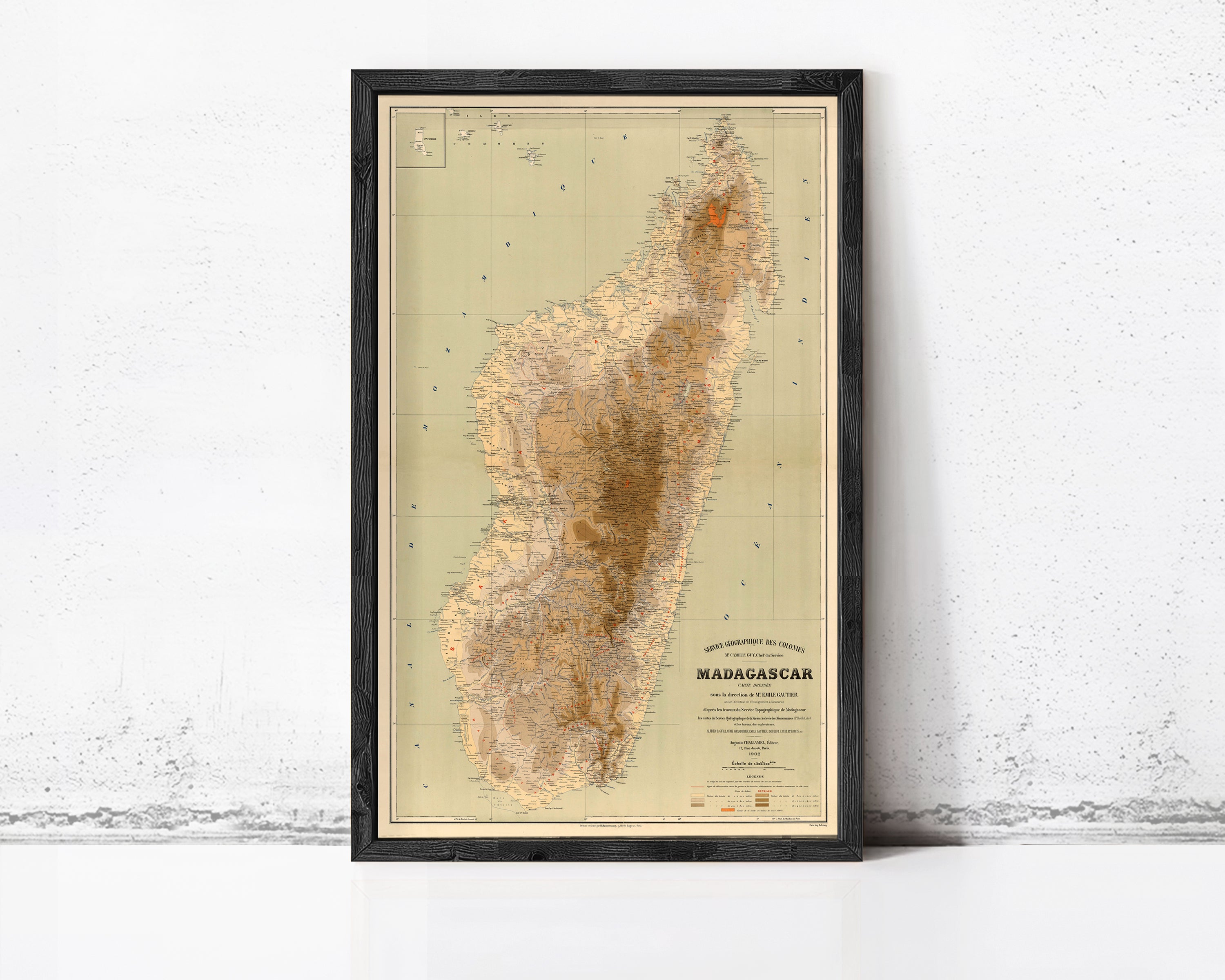 The image is a framed map of Madagascar, a country in the South Pacific, with a vintage style and a beige color scheme.