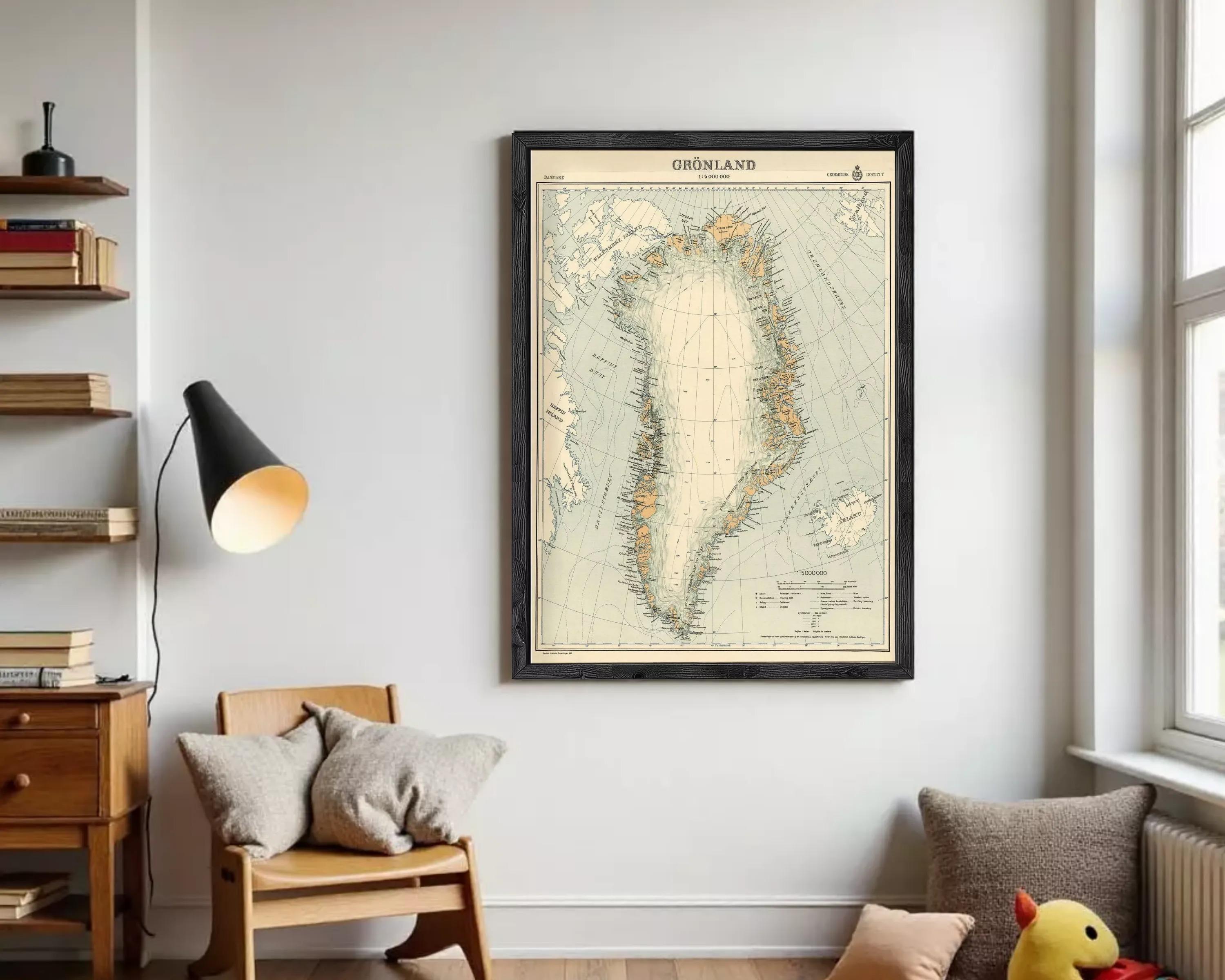 a framed map of Greenland hanging on a wall in a living room.
