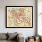 a large framed map of the city of Geneva, Switzerland, hanging on a wall above a couch in a living room.