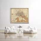 a large framed map of Baltimore, Maryland, hanging on a white wall above two white bean bag chairs and a small black table.