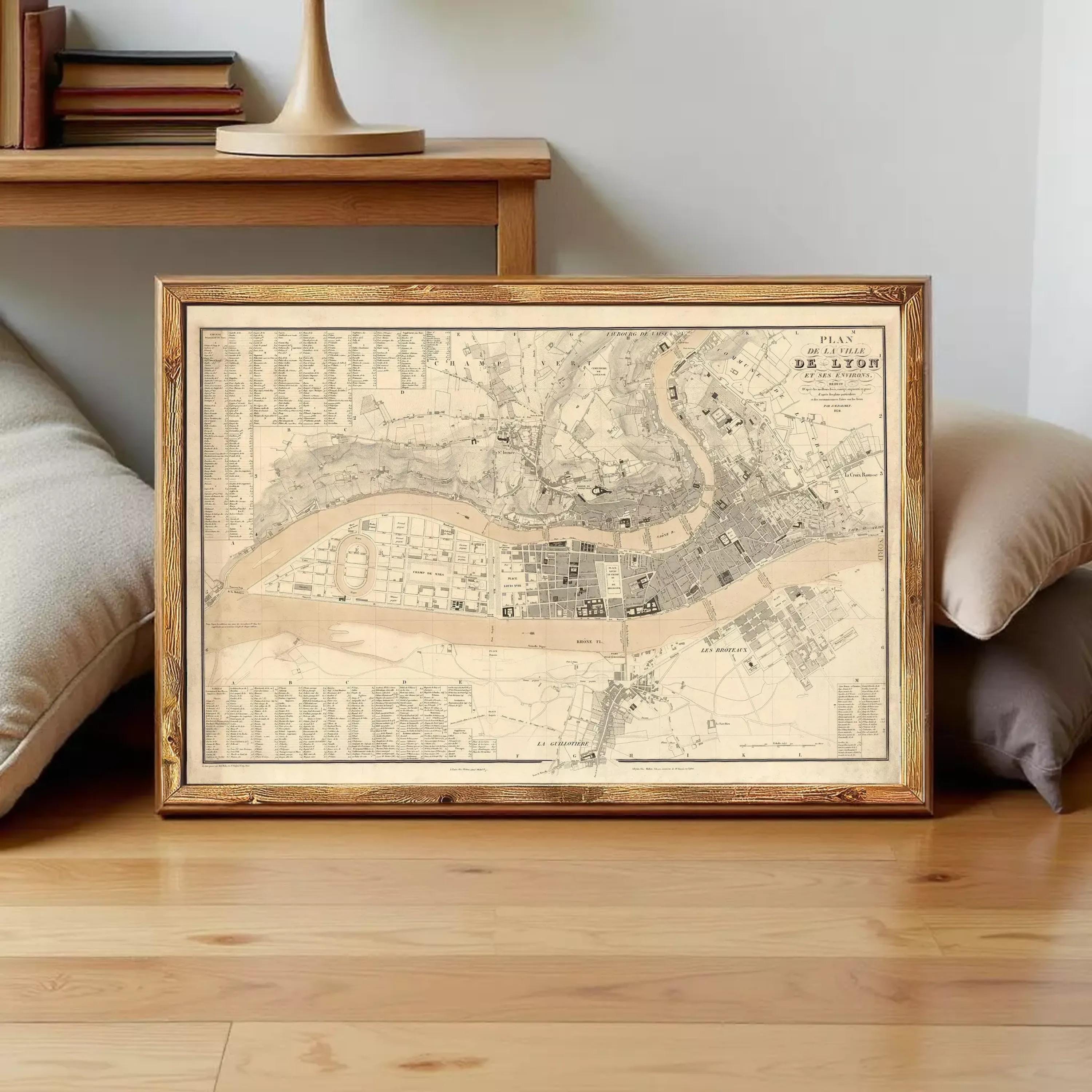 The image is a framed map of a city, likely from the 19th century, displayed on a white wall.
