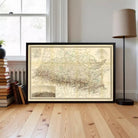 A framed map of the United States, specifically the state of Oklahoma, is displayed on a wooden floor in a room with a window and a lamp.