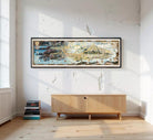 A large, colorful, and detailed map of a coastal region or island, displayed in a frame against a plain white wall.