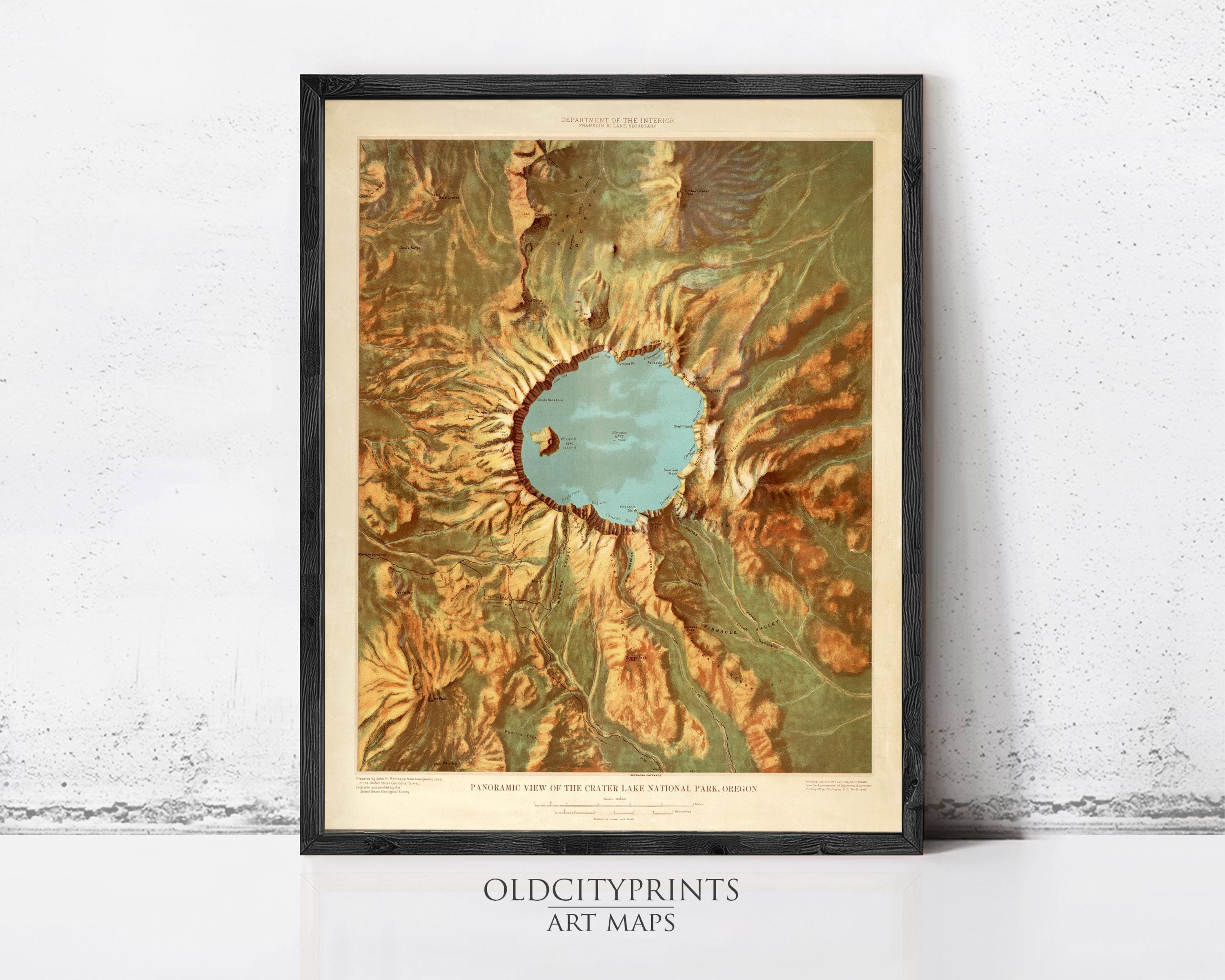 The image is a framed art print depicting a panoramic view of a mountainous region, with a prominent blue lake or body of water in the center.