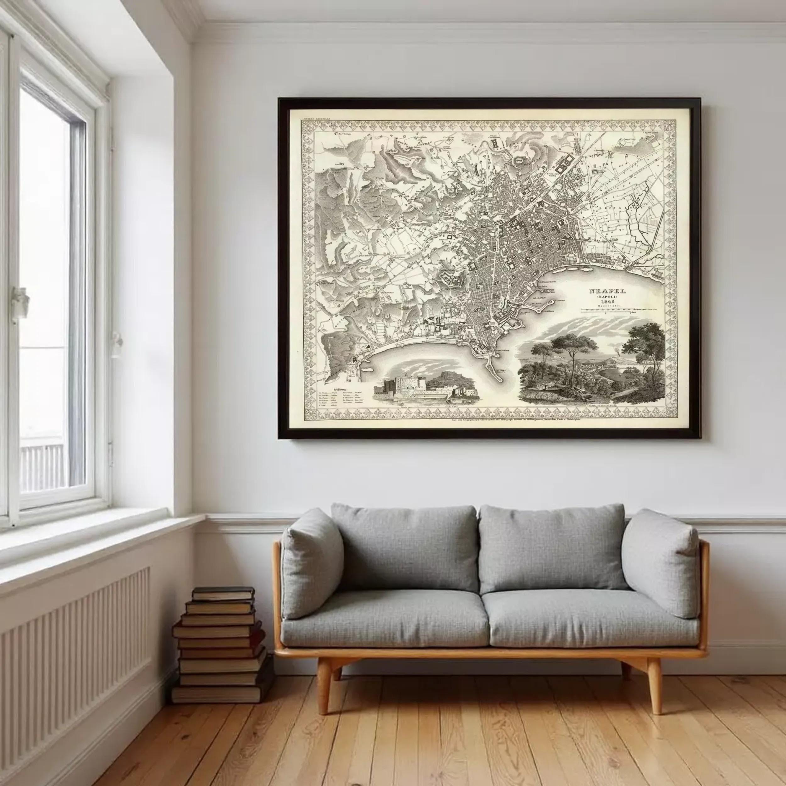 a large framed map of the United States hanging on a wall above a gray sofa in a room with a window.
