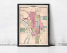 The image is a framed map of the city of Wichita, Kansas, depicting the layout of the city with streets, buildings, and other landmarks.