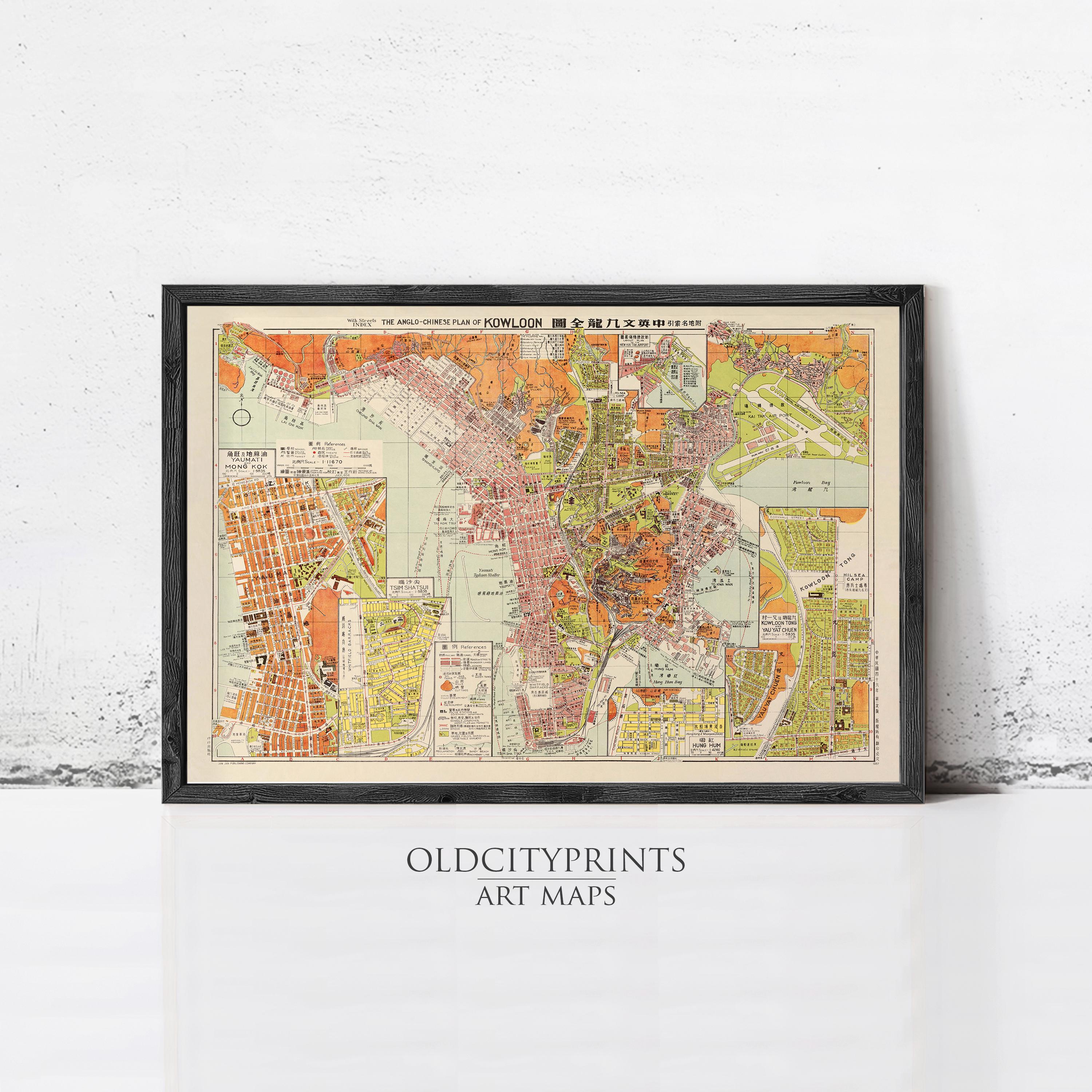 The image is a framed vintage map of a city, likely from the early 20th century, with various colored areas representing different neighborhoods or districts.