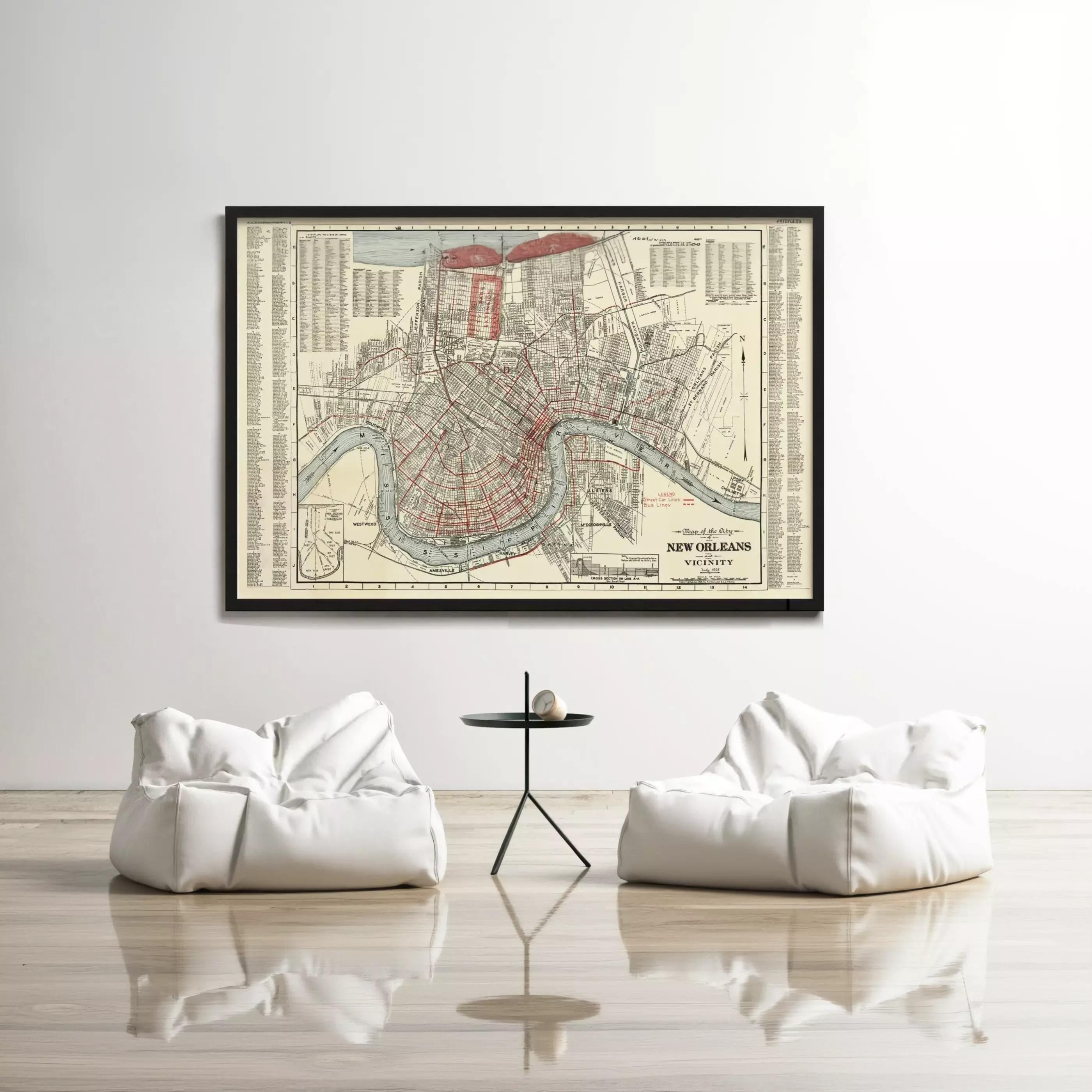 a large framed map of New Orleans hanging on a white wall, with two white bean bag chairs positioned in front of it.