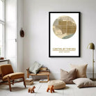 a living room with a large framed map of Carmel by the Sea hanging on the wall, a wooden bench, a brown chair, and some books and decorative items on the floor.