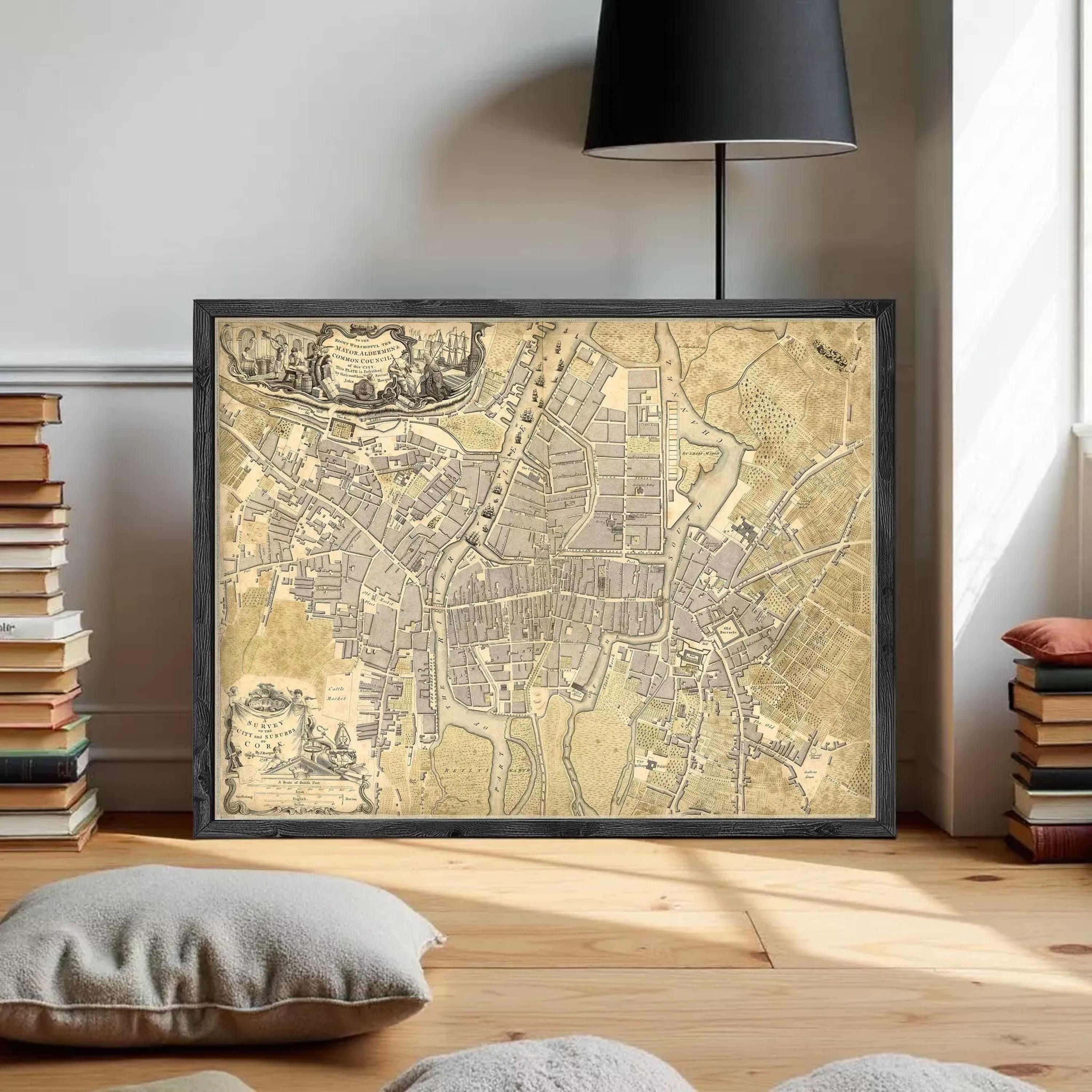 The image is a framed antique map of a city, likely from the 16th century, displayed on a white wall.