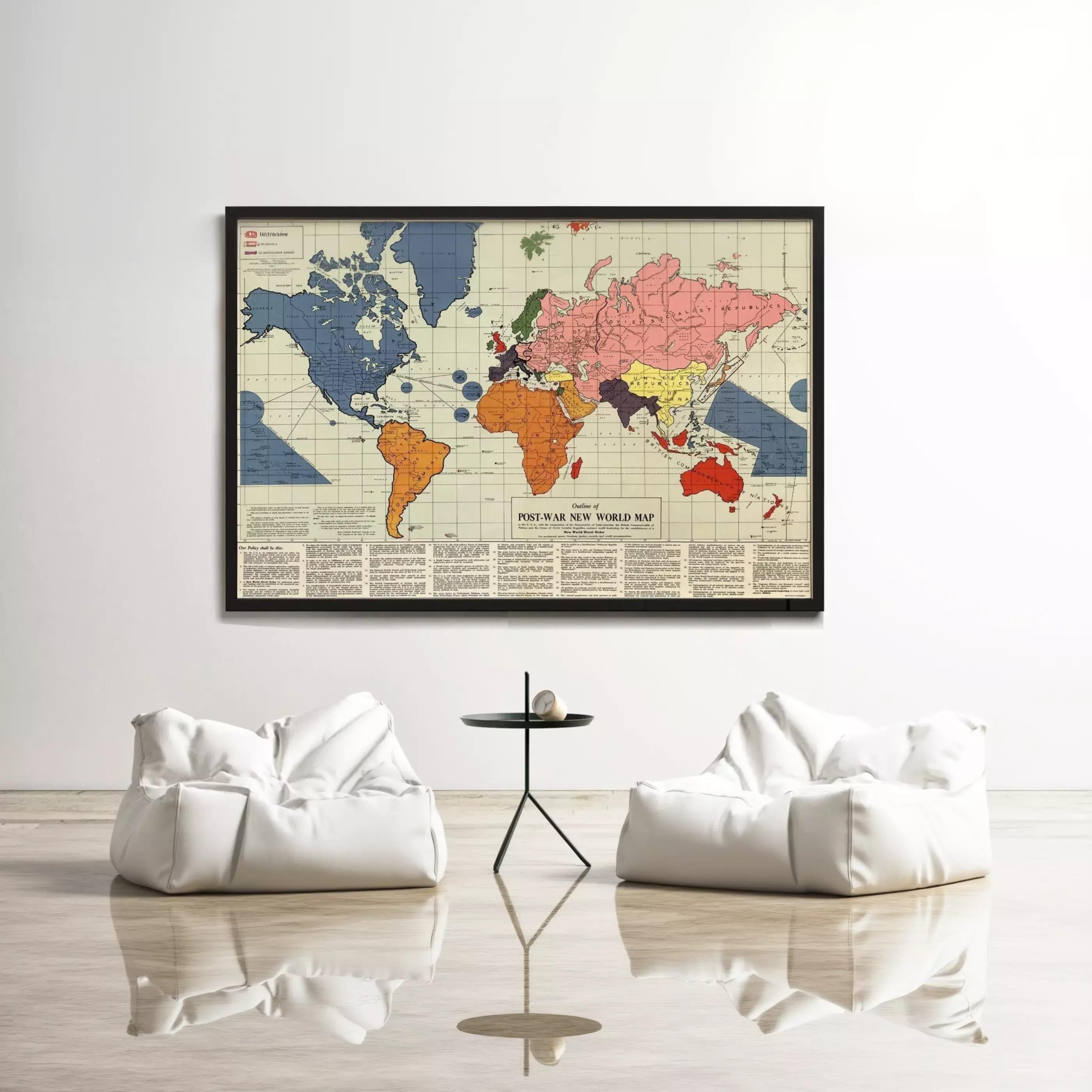a large world map hanging on a white wall, with two white bean bag chairs positioned in front of it.