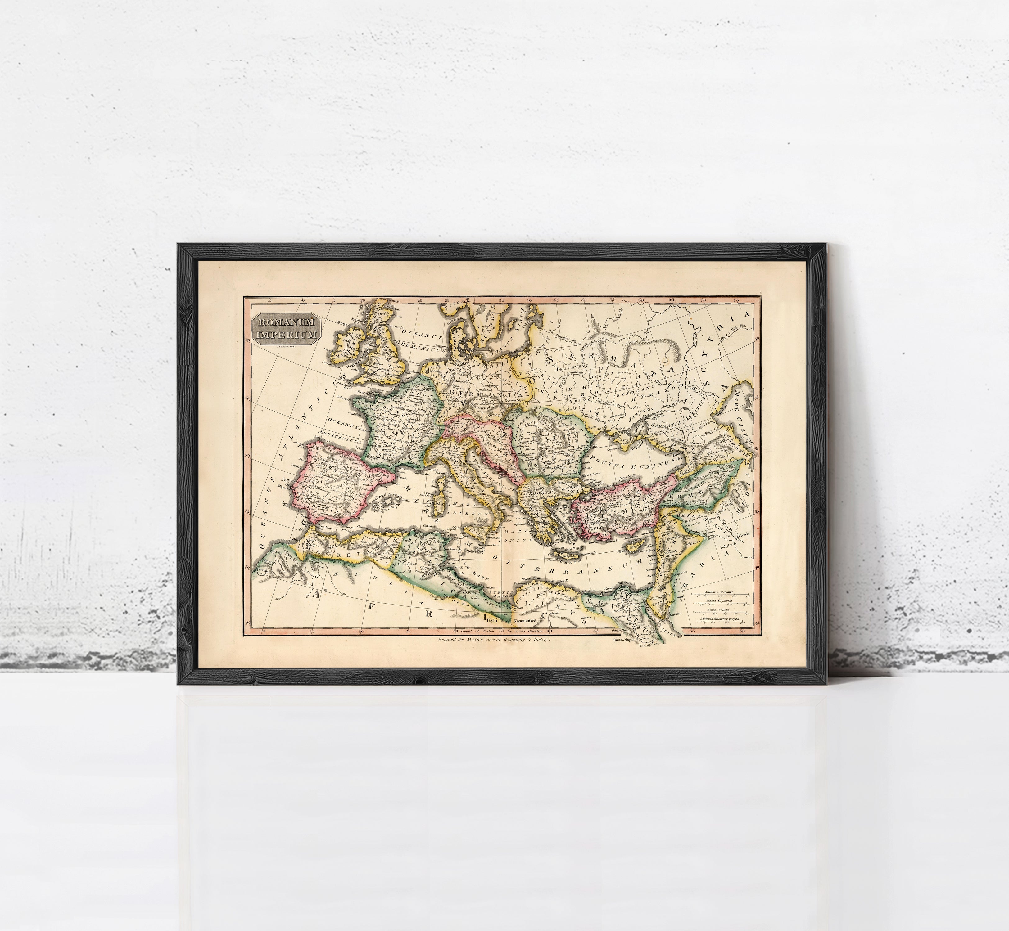 The image is a framed antique map of Europe and the Mediterranean region, displayed on a white wall.