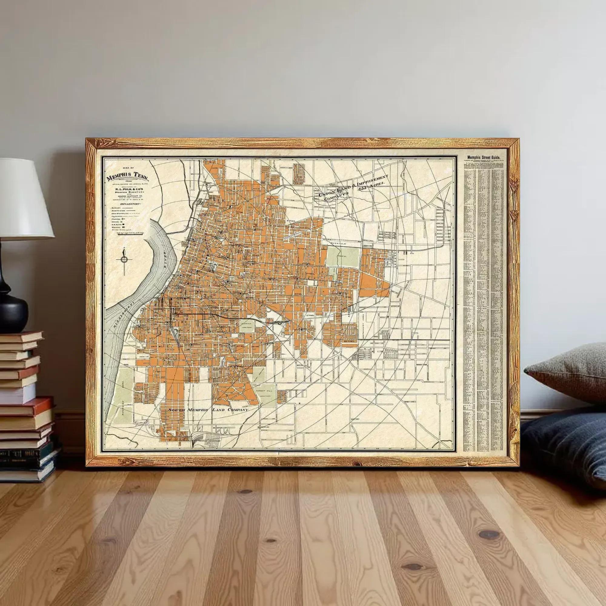 a large, framed map of a city, likely a vintage or antique map, displayed on a wooden floor against a wall.