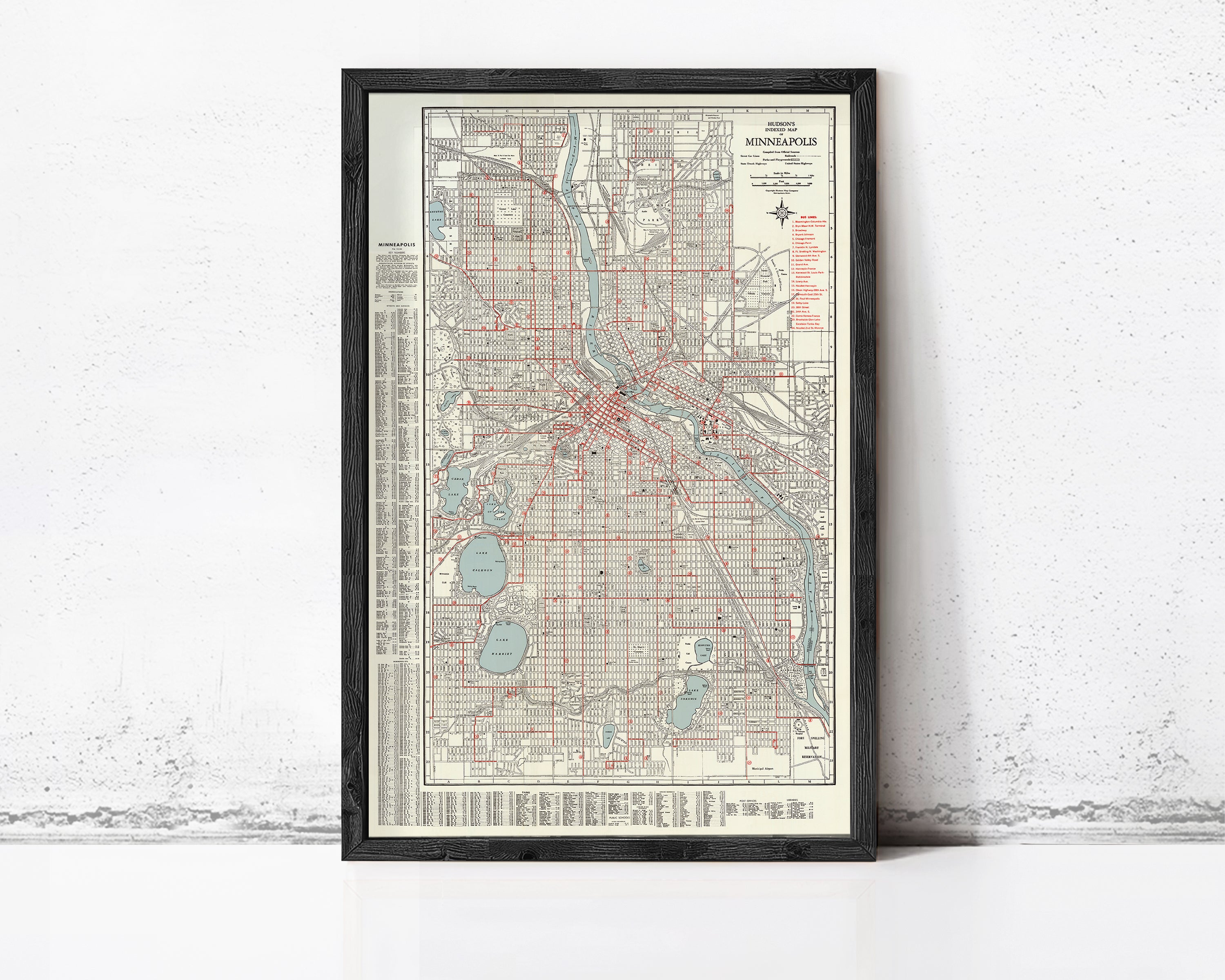 The image is a framed map of Minneapolis, Minnesota, with a detailed layout of the city's streets, landmarks, and other geographic features.