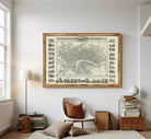 The image is a framed vintage map of London, England, with various landmarks and streets depicted in a detailed and intricate manner.