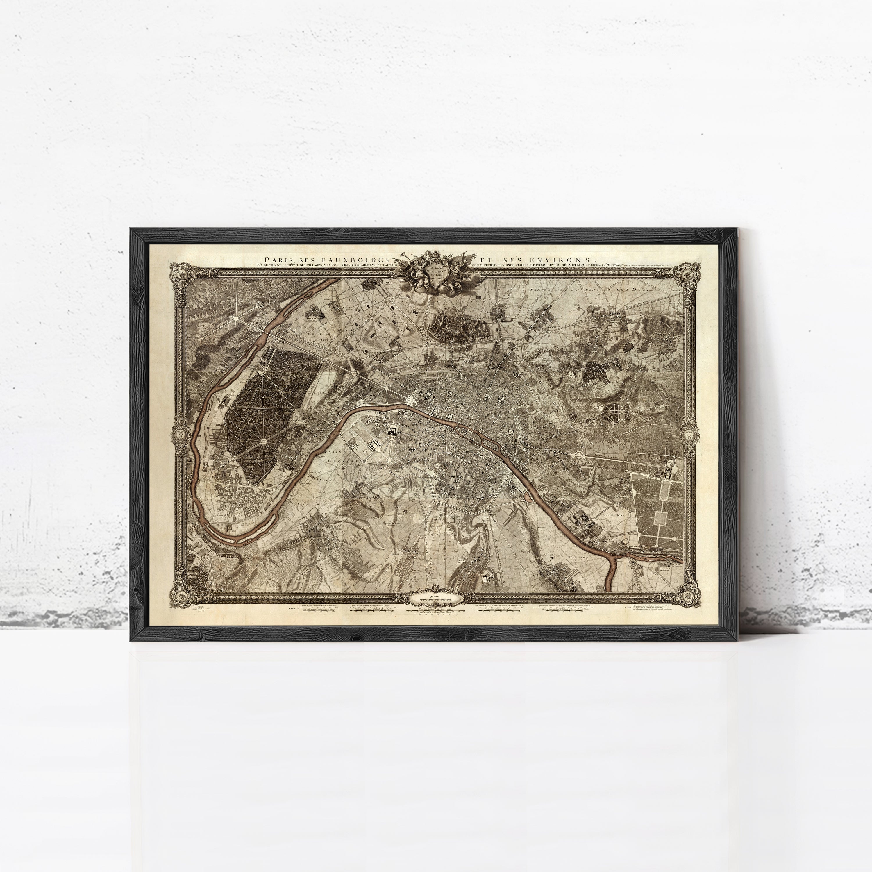 The image is a framed vintage map of Paris, France, depicting the city's streets and surrounding areas.