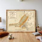 a large framed map of Western Australia, with a teddy bear sitting on the floor in front of it.