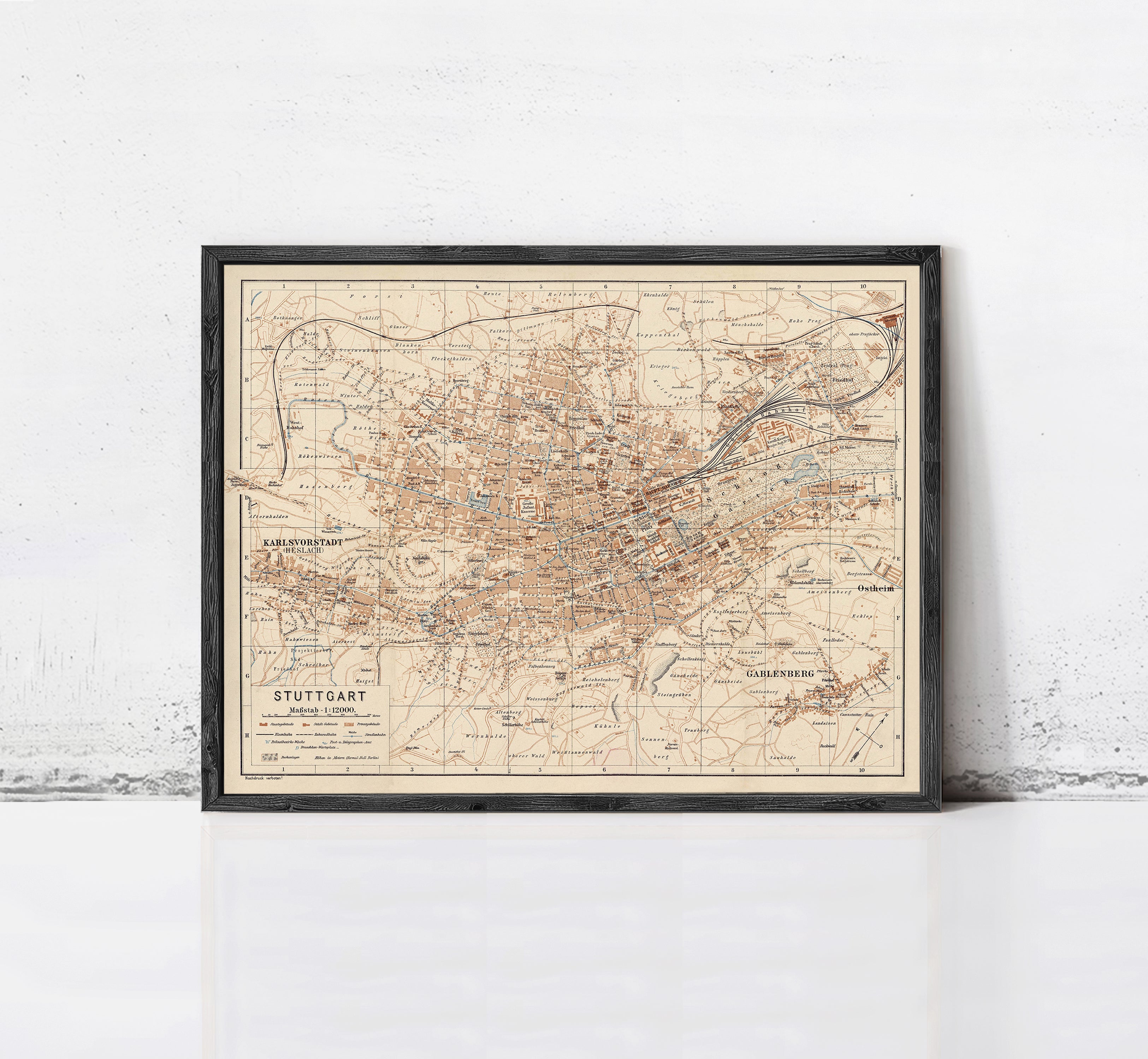 The image is a framed vintage map of Stuttgart, Germany, depicting the city's layout and surrounding areas.